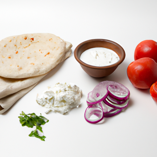 Fresh ingredients for making a traditional Greek gyro, including pita bread, tomatoes, onions, and tzatziki sauce